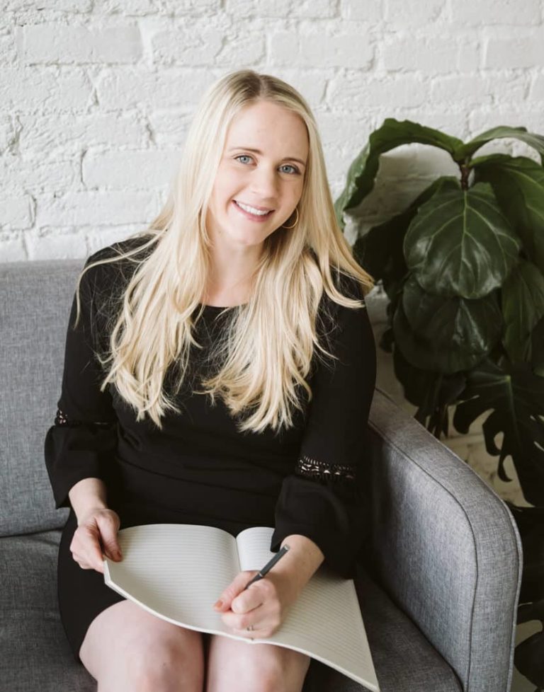 Olivia Sloan, event planner, with notebook and pen, creating memorable events in Tacoma, WA
