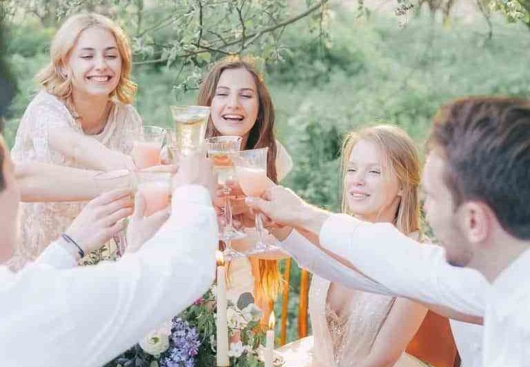 Group of people celebrating with drinks at a private party event planned by Olivia Sloan Events.
