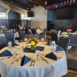 Corporate dinner at round tables at the Tacoma Yacht Club
